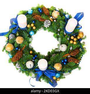 Christmas wreath isolated on white background, top view of New Year composition with candles and ornaments. Christmas decoration made of natural green Stock Photo