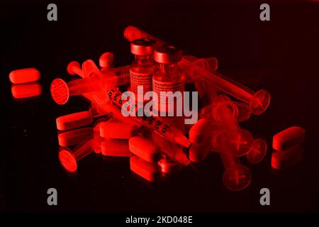 An illustrative image of medical syringes, medical pills and two Pfizer-BioNTech Covid-19 vaccine vials. On Monday, January 10, 2021, in Edmonton, Alberta, Canada. (Photo by Artur Widak/NurPhoto) Stock Photo