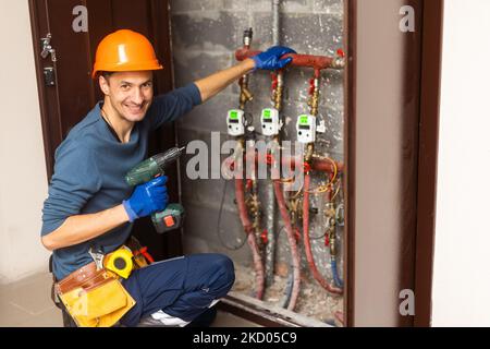 Technician inspecting heating system in boiler room Stock Photo