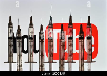 Illustrative photo of medical syringes seen in front of a YouTube logo displayed on a computer screen. On Thursday, January 14, 2021, in Edmonton, Alberta, Canada. (Photo by Artur Widak/NurPhoto) Stock Photo