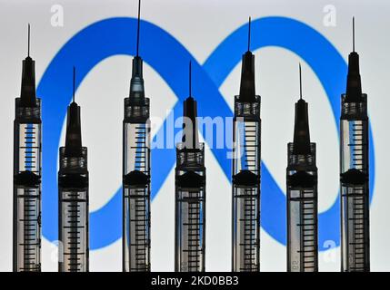 Illustrative photo of medical syringes seen in front of a Meta logo displayed on a computer screen. On Thursday, January 14, 2021, in Edmonton, Alberta, Canada. (Photo by Artur Widak/NurPhoto) Stock Photo