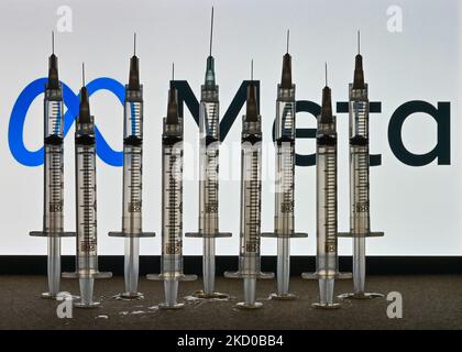 Illustrative photo of medical syringes seen in front of a Meta logo displayed on a computer screen. On Thursday, January 14, 2021, in Edmonton, Alberta, Canada. (Photo by Artur Widak/NurPhoto) Stock Photo