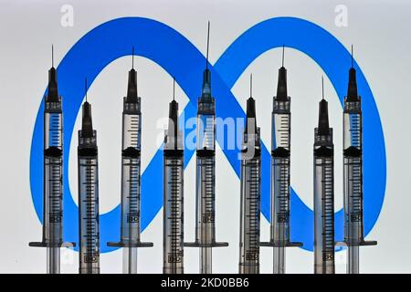 Illustrative photo of medical syringes seen in front of a Meta logo displayed on a computer screen. On Thursday, January 14, 2021, in Edmonton, Alberta, Canada. (Photo by Artur Widak/NurPhoto) Stock Photo