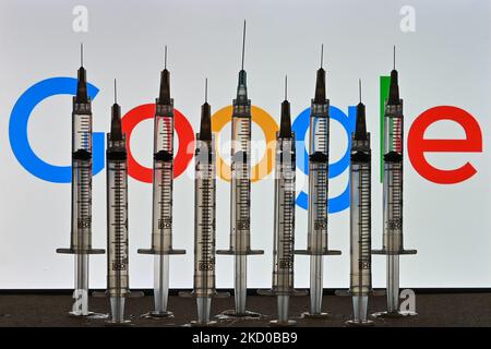 Illustrative photo of medical syringes seen in front of a Google logo displayed on a computer screen. On Thursday, January 14, 2021, in Edmonton, Alberta, Canada. (Photo by Artur Widak/NurPhoto) Stock Photo