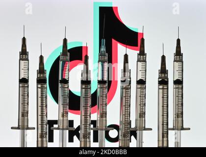 Illustrative photo of medical syringes seen in front of a TikTok logo displayed on a computer screen. On Thursday, January 14, 2021, in Edmonton, Alberta, Canada. (Photo by Artur Widak/NurPhoto) Stock Photo