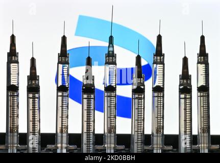 Illustrative photo of medical syringes seen in front of a Pfizer logo displayed on a computer screen. On Thursday, January 14, 2021, in Edmonton, Alberta, Canada. (Photo by Artur Widak/NurPhoto) Stock Photo