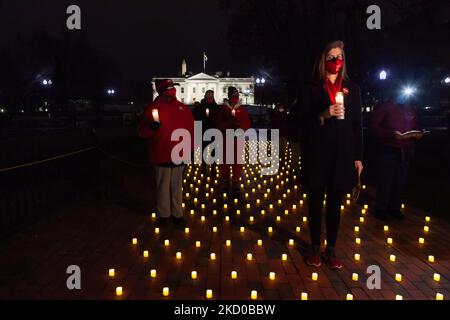 Members of National Nurses United stand among hundreds of candles during a vigil for nurses lost to Covid-19. The vigil was the culmination of a national day of action by the National Nurses Union (NNU) demanding better coronavirus protections for nurses. NNU has two demands: make the enhanced OSHA Covid protections for health care workers permanent, and retraction of the CDC's recently-issued weaker guidelines for isolation. (Photo by Allison Bailey/NurPhoto) Stock Photo