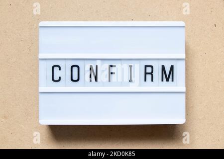 Lightbox with word confirm on wood background Stock Photo