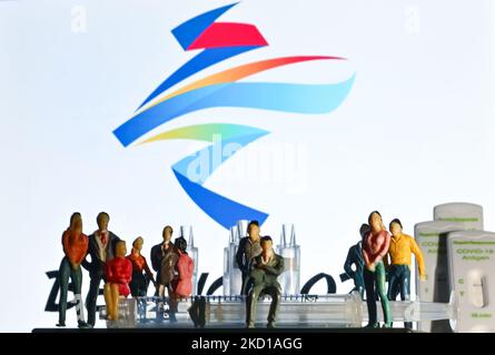 Illustration of a medical syringe, negative Covid-19 antigen tests, and figurines of athletes and spectators seen in front of the official Beijing 2022 Winter Olympic Games emblem displayed on a computer screen. On Thursday, January 27, 2022, San Cristobal de las Casas, Chiapas, Mexico. (Photo by Artur Widak/NurPhoto) Stock Photo