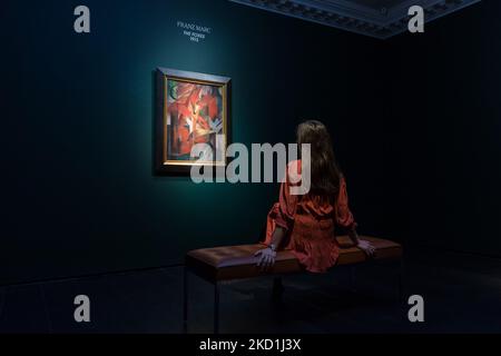 LONDON, UNITED KINGDOM - JANUARY 31, 2022: A staff member looks at 'The Foxes' (1913) by Franz Marc, estimate on request (in the region of £35,000,000), during a photo call to present the centrepiece of the 20th / 21st Century: London Evening Sale taking place on 1st March at Christie's auction house on January 31, 2022 in London, England. (Photo by WIktor Szymanowicz/NurPhoto) Stock Photo