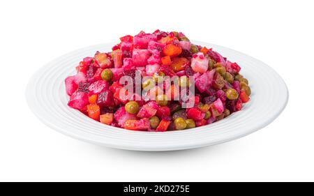 Vinaigrette, vegetable salad with peas and sauerkraut and fresh herbs is isolated on a white background. Stock Photo