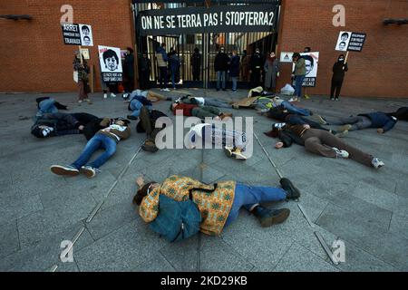 Activists do a die-in in front of the locked gates of the Regional council of Occitania. Three activist were 'neck locked' to the gates .Several dozens of activists from XR, ANV-COP21, ATTAC, Youth for Climate gathered in front of the Regional Council of Occitania to protest against the building of a giant warehouse called Terra2 near Toulouse. They are opposed to this giant warehouse projected for Amazon or Alibaba as it will cover several agricultural fields. The Terra2 wharehouse shoud be 533 m lenght, 125m wide and 14m height, it would be in the top 10 of the biggest warehouses in France.  Stock Photo