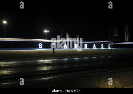 A man walks past the Starbase sign at SpaceX's South Texas campus late ...