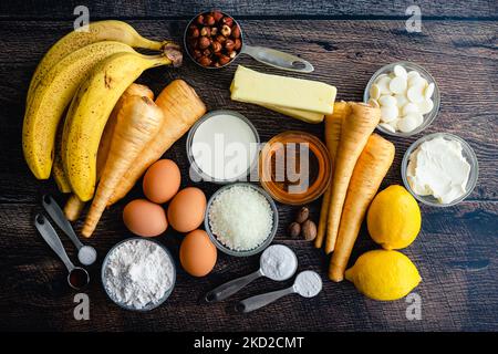 Melted Candle Cakes Ingredients Flatlay: Raw ingredients for parsnip-banana cakes with a white chocolate glaze Stock Photo