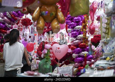 People wear protective face masks buy valentines gift for valentine's Day at a market in Bangkok, Thailand, 12 February 2022. Thailand reported 16,330 new coronavirus cases in the last 24 hours. (Photo by Anusak Laowilas/NurPhoto) Stock Photo