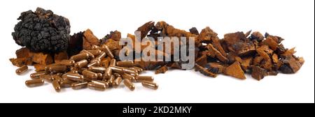 Chaga Mushroom with Capsules Panorama isolated on white Background - Healthy Nutrition Stock Photo