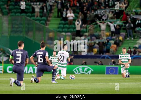 Players knelt at the start of the Round Of Sixteen Leg One - UEFA Champions League match between Sporting CP and Manchester City at Alvalade stadium in Lisbon, Portugal, on February 15, 2022. (Photo by Pedro FiÃºza/NurPhoto) Stock Photo