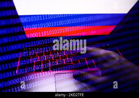 Russian flag displayed on a laptop screen and binary code code displayed on a screen are seen in this multiple exposure illustration photo taken in Krakow, Poland on February 16, 2022. (Photo illustration by Jakub Porzycki/NurPhoto) Stock Photo