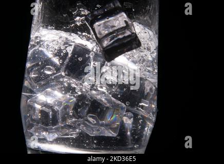 An abstract shapes formed as ice falls into refreshing water. Black and white Stock Photo