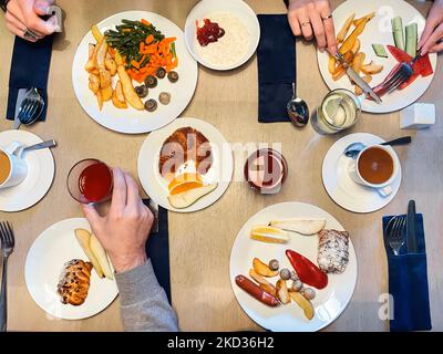 Many hand sharing and eating their food. Breakfast concept with family or friends Stock Photo