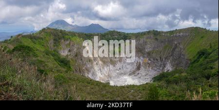 Panoramic view of Mount Mahawu volcano crater, with Mount Lokon in background, near Tomohon, North Sulawesi, Indonesia Stock Photo