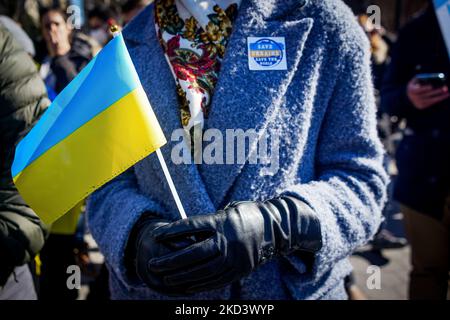 A demonstrator holds a Ukrainian flag at Washington Square Park Sunday February 27, 2022 in New York, NY. Earlier today, Vladimir Putin announced that nuclear forces would be put on high alert in response to aggressive statements made by leading NATO powers. (Erin Lefevre/NurPhoto) (Photo by Erin Lefevre/NurPhoto) Stock Photo