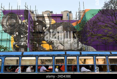 A private bus passes by a wall graffiti of a famous late Indian film Satyajit Ray is seen in Kolkata, India, 02 March, 2022. (Photo by Indranil Aditya/NurPhoto) Stock Photo