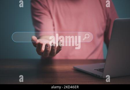 Search Engine Optimization SEO Networking Concept, Hand of businessman working with computer, holding search box, browsing Internet global data Inform Stock Photo