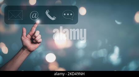Hand touching on communication customer service contact icon, E-mail, Phone number, Social media group. Stock Photo