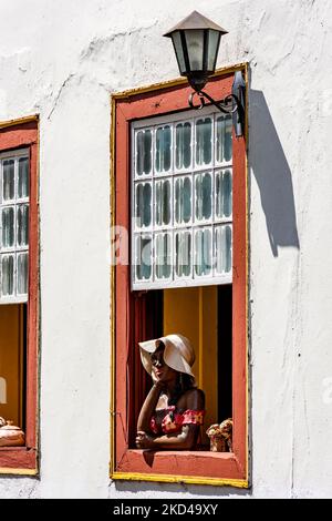 Window decorated with flowers and objects in the historic historic city of Diamantina in a typical scene of the interior of the state of Minas Gerais Stock Photo