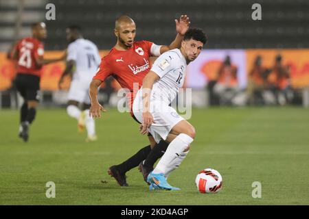 Murad Naji (12) of Al Wakrah on the ball as Yacine Brahimi (8) of Al Rayyan closes in during the Amir Cup quarter final between Al Rayyan and Al Wakrah at the Jassim Bin Hamad Stadium in Doha, Qatar on 5 March 2022. (Photo by Simon Holmes/NurPhoto) Stock Photo