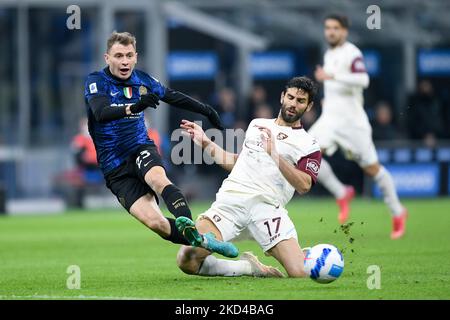 Nicolo' Barella of FC Internazionale and Federico Fazio of US Salernitana 1919 compete for the ball during the Serie A match between FC Internazionale and US Salernitana 1919 at Stadio Giuseppe Meazza, Milan, Italy on 4 March 2022. (Photo by Giuseppe Maffia/NurPhoto) Stock Photo