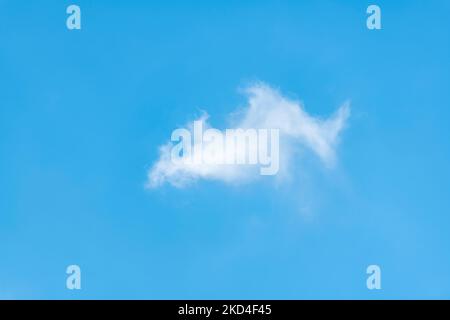 Isolated white cloud against light blue sky Stock Photo