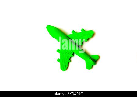 Children toy - green plastic plane with a red propeller, without a pilot, isolated on a white background. Stock Photo