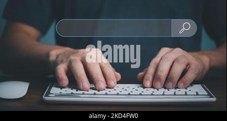 Hand of businessman working with computer, Searching Browsing Internet Data Information with blank search bar. Search Engine Optimization SEO Networki Stock Photo