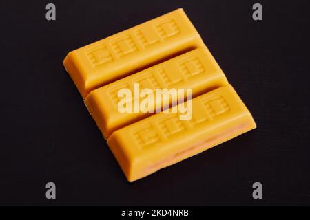 unwrapped McVities Gold Bars - golden chocolate bar snack treats without wrapper isolated on black background Stock Photo