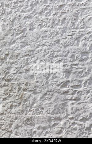 abstract background of plain white stucco textured wall vertical format Stock Photo