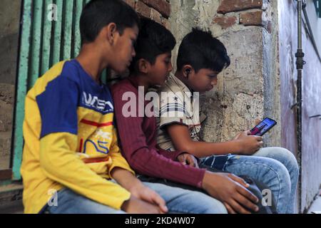 Children enjoy TikTok video in mobile phone in Dhaka, Bangladesh on March 11, 2022. (Photo by Kazi Salahuddin Razu/NurPhoto) Stock Photo