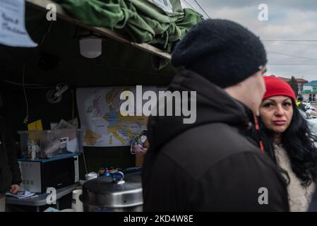 A map of western Europe is seen in the background while a volounter is distributing information to Ukrainian citizens who have cross the border and reached the city of Otaci, northern Moldova, on 10-03-2022. (Photo by Matteo Placucci/NurPhoto) Stock Photo