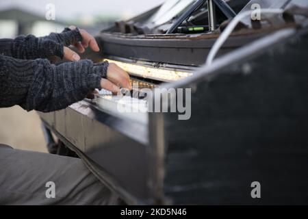 German pianist of Italian descent Davide Martello known as Klavierkunst performs in Medyka, at the Ukrainian Polish border crossing of Medyka Shehyni. The musician, an artist plays grand piano near the Ukrainian border for the arriving war refugees from Ukraine in front of the tents and the buses that get them to relocate. Thousands of civilian refugees cross the Ukrainian-Polish border daily due to the Russian invasion of Ukraine. Medyka, Poland on March 14, 2022 (Photo by Nicolas Economou/NurPhoto) Stock Photo