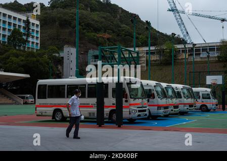A driver looks at the ambulance buses which are parked on a basket ball terrain near the United Christian Hospital in Kwun Tong, in Hong Kong, China, on March 24, 2022. (Photo by Marc Fernandes/NurPhoto) Stock Photo