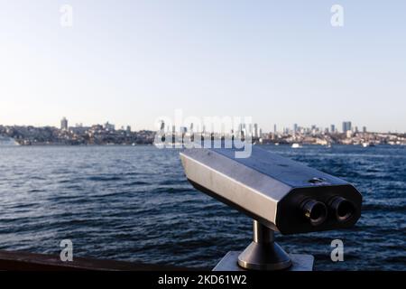 Binoculars close up. A ship on a river or sea sails out of the port, approaches, monocle, spyglass, nautical tourism, sailor, coast, waves. View of a Stock Photo