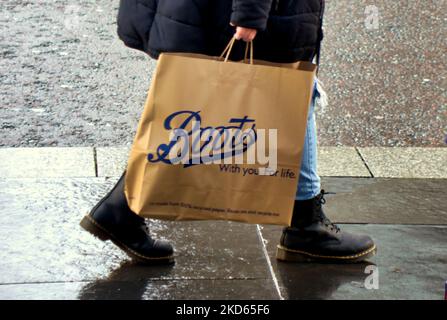 boots the chemist bag walking customer in boots close up Stock Photo