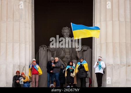 Protesters stand with Ukrainian flags in front of the statue of Lincoln during a rally marking the one-month anniversary of Russia’s war at the Lincoln Memorial Hundreds of people attended the event at the Lincoln Memorial to support the Ukrainian people in their fight for independence. The rally featured remarks by Ukrainian President Volodymyr Zelenskyy (via video), Ukraine’s Ambassador to the US Oksana Markarova, and former US Ambassador to Ukraine Marie Yovanovitch. Protesters continued their demands for a no-fly zone over Ukraine and expulsion of all Russian banks from the SWIFT system. ( Stock Photo