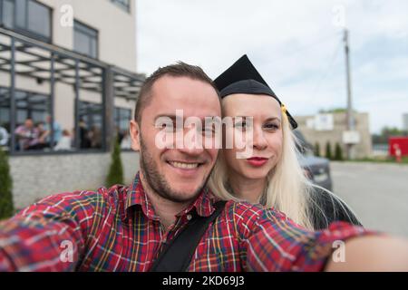 Black woman confidently taking a selfie on a sofa in her modern living ...