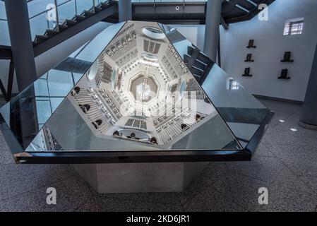 Reflections of the  displays  located on the sides of the tower at The Royal Armouries Museum in Leeds Yorkshire  ( & above the 'Hall of Steel'). Stock Photo