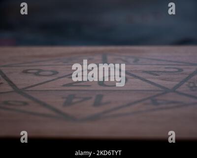 a 12 sided die carved into a box lid being made out of walnut Stock Photo