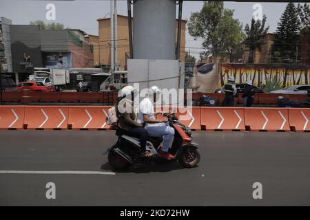 A couple riding a motorbike on Avenida Tláhuac in the Iztapalapa district of Mexico City, where rehabilitation work is being carried out on Line 12 of the Metro Collective Transport System after a structure collapsed between the Tezonco and Olivos stations on 3 May 2021, where 27 people died and a hundred were injured. (Photo by Gerardo Vieyra/NurPhoto) Stock Photo