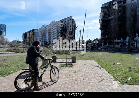 A cyclist is seen near the damaged residential buildings by the Russian air raids in Borodyanka , Bucha Raion of Kyiv Oblast, on 7 April 2022. (Photo by Ceng Shou Yi/NurPhoto) Stock Photo