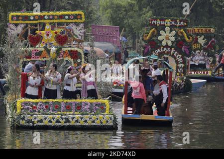 Representatives of La Flor Más Del Ejido in Xochimilco, Mexico City, aboard a canoe decorated with flowers during a tour of the Embarcadero Nuevo de Nativitas on the occasion of this contest, which aims to highlight the diversity of native women of this municipality, as well as to preserve and highlight the origins of the people who still preserve their customs and traditions. (Photo by Gerardo Vieyra/NurPhoto) Stock Photo